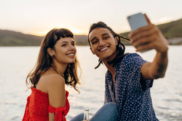 istock Happy young couple taking selfies while on a vacation 1341881410