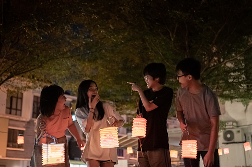 Asian Chinese sibling and cousin  holding paper lantern, celebration mid autumn festival.