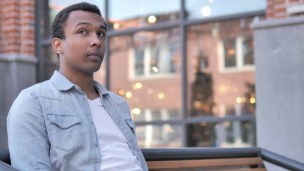 istock Waiting African Man Sitting Outdoor 1341882039