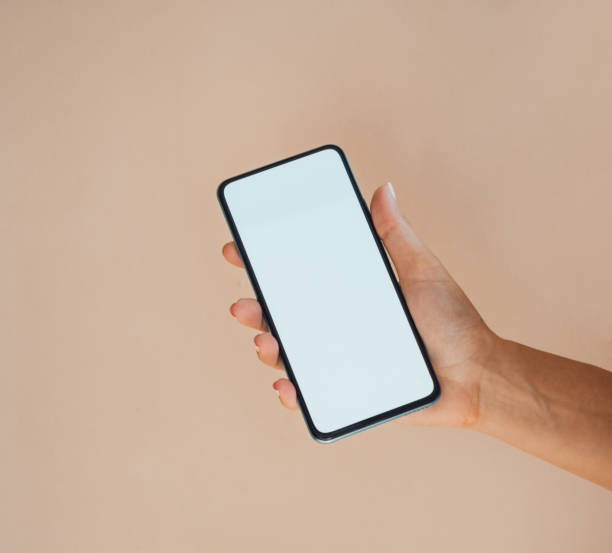 istock An Anonymous Woman Holding Mobile Phone with Empty Screen on Orange Background 1341882763