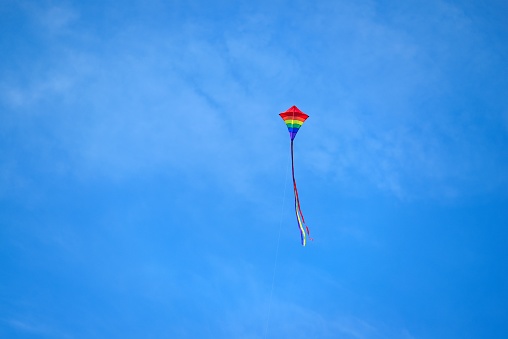 A young boy is flying his kite in the morning ocean breeze at the Assateague Island National Seashore, Maryland in september
