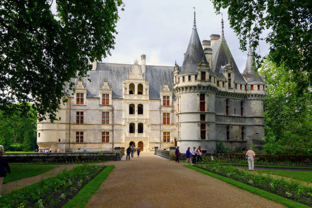 Azay-le-Rideau, France - June 12, 2010: Front view of the castle, in the Loire Valley region. A wide alley leads towards the castle walls.