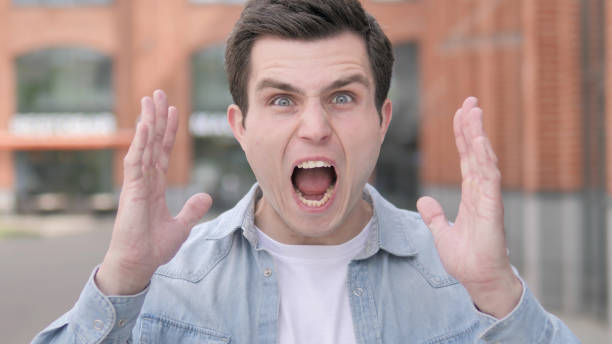 istock Angry Young Man Screaming Outdoor 1341884966