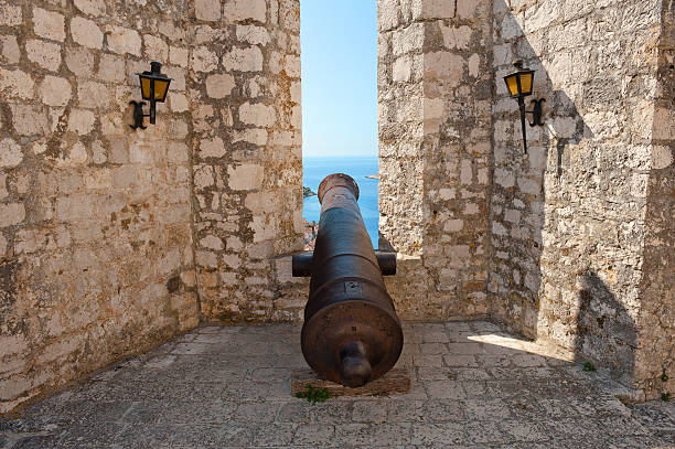 Old cannon in ancient fortress on seaside. Hvar, Croatia stock photo