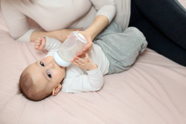 istock Baby drinking from a bottle 1341888316