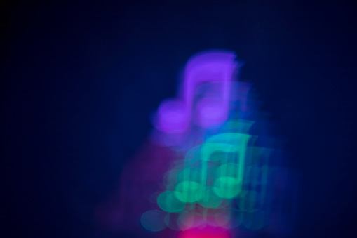 Abstract background with defocused lights bokeh with musical note shape. It's a REAL bokeh photo, not an illustration or computer filter.