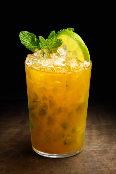 Appetizing caipirinha fruit cocktail against black background Close up of refreshing caipirinha fruit cocktail against black background. drinking mango juice stock pictures, royalty-free photos & images