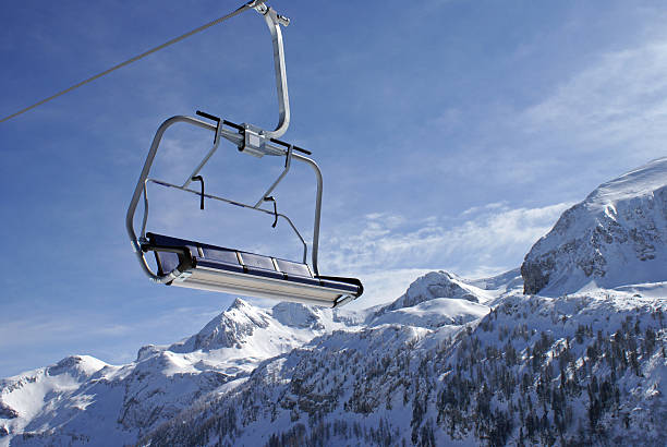 Chairlift on a sunny day in the Alps.