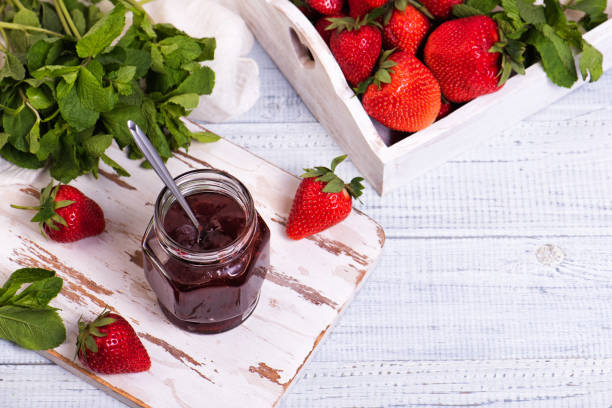 istock Jar of strawberry jam on wooden rustic board. 1341890777