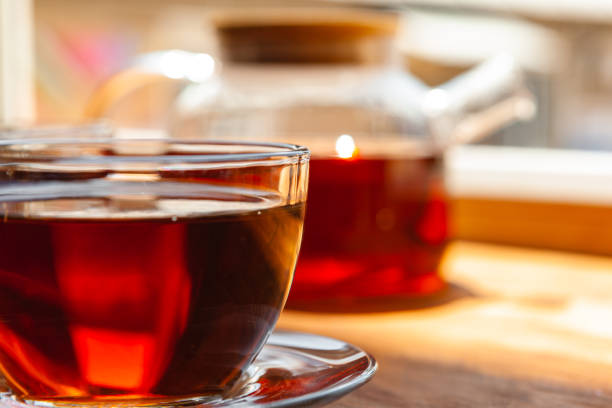 istock Hot cup of tea on wooden rustic table close up 1341890790