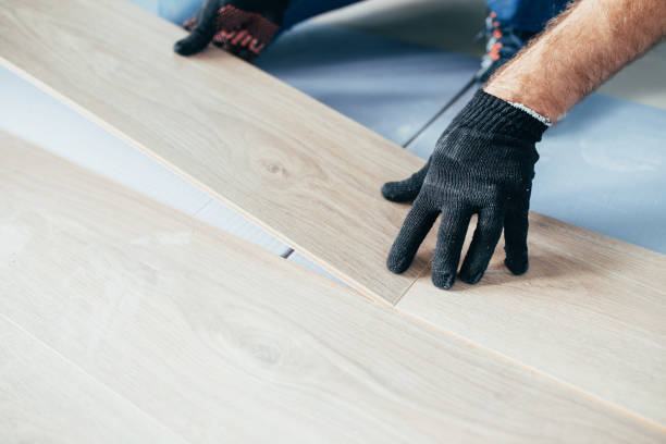 istock The laminate master connects the panels into one whole - do-it-yourself flooring 1341890940