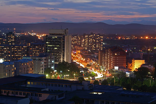 Prishtina at Night Prishtina, Kosovo: Downtown in Kosovo's capital city in the evening. Traffic on "Bill Clinton Boulevard" appears as streaks in the long-exposure. pristina stock pictures, royalty-free photos & images