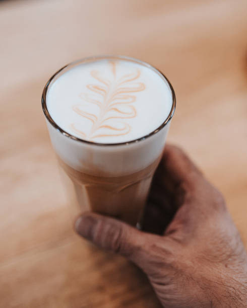 istock Professional barista makes cappuccino 1341895749