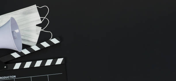 istock Black clapper board or movie clapperboard or slate and magaphone on black background.it use in video production and movie industry. 1341895901