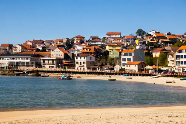 Aldán  beach and village, Cangas do Morrazo, Rías Baixas, Pontevedra province, Galicia, Spain. Village houses by the sand.