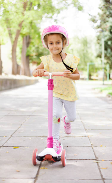 istock girl with push scooter 1341896138