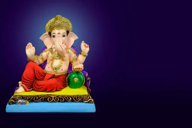 Photo of Hindu God Ganesha on colorful background