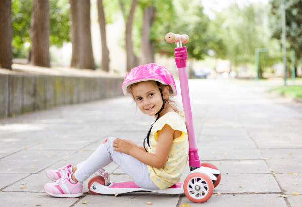 istock girl with push scooter 1341897290