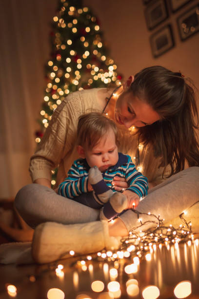istock Mother and son playing with Christmas lights 1341898720