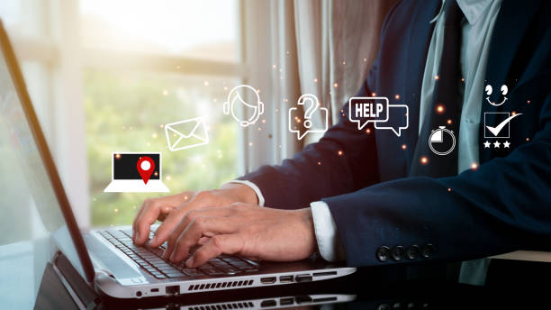 istock Hotline for customer service Contact us people connection. Businessman utilizing computer keyboard with the email, call phone, address, Chat message icons. 1341899818