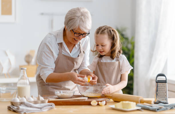 family are preparing bakery together - grandmother cooking baking family imagens e fotografias de stock