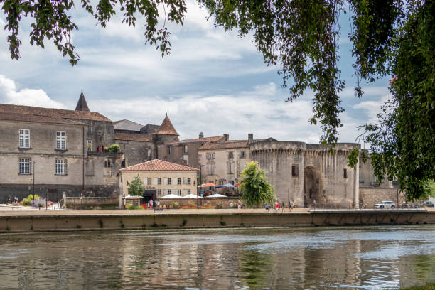 The Old Town of Cognac built on the river's left bank of the Charente river in southwestern France, Europe Cognac, France - July, 2021 : The Old Town of Cognac built on the river's left bank of the Charente river in the commune in the Charente department in southwestern France, Europe cognac region photos stock pictures, royalty-free photos & images
