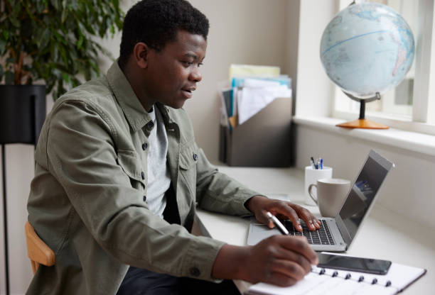 istock Enthisiastic Young Man Working From Home On Laptop 1341903483