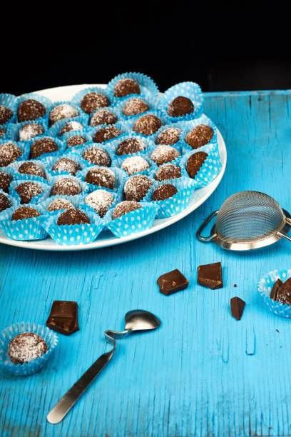 istock Christmas chocolate ball, spoon and colader on blue wooden table. 1341903612