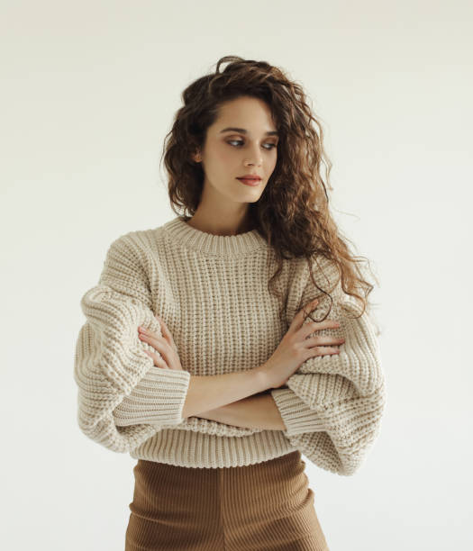 istock Young beautiful woman wearing beige sweater 1341903983
