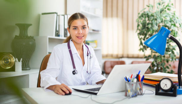istock Young woman doctor is working at a computer in the office 1341904630