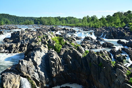 With moderate water levels, the falls and rock formations of Great Falls are well defined in a view from the Virginia side of the Potomac River.