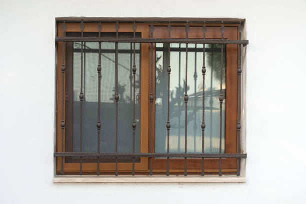 istock window fence on white stone wall. 1341907823