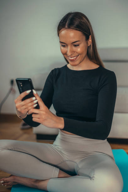 istock Woman taking selfie with her smartphone while training at home 1341908119