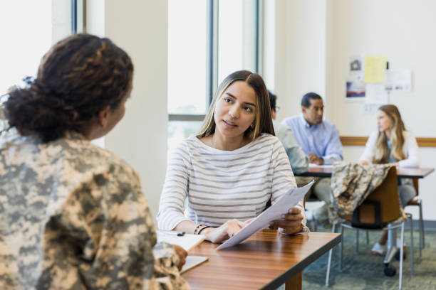 istock Unrecognizable female soldier and female recruit discuss application 1341908177