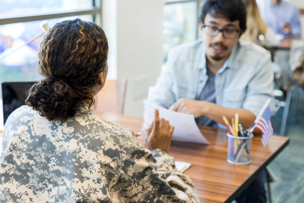 istock Unrecognizable soldier and mid adult man discuss paperwork 1341908207