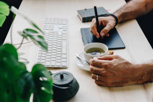 istock Unrecognizable man works with his graphic tablet 1341909630