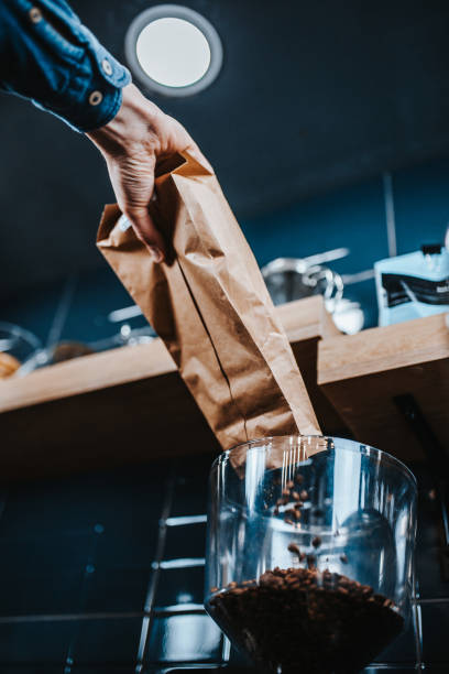 istock Pours coffee beans into an electric coffee grinder 1341911655