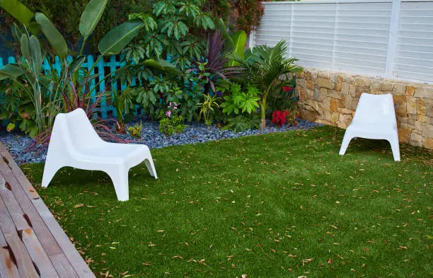 Photo of tropical garden with artificial grass turf wood deck