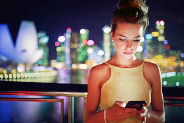 istock Young woman is texting in the night city 1341912042