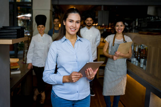 istock Business owner at a restaurant leading her staff and smiling 1341912062