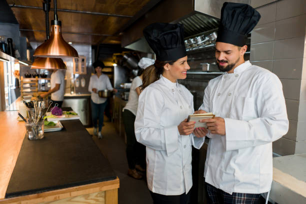 istock Team of chefs working together at a restaurant 1341912099