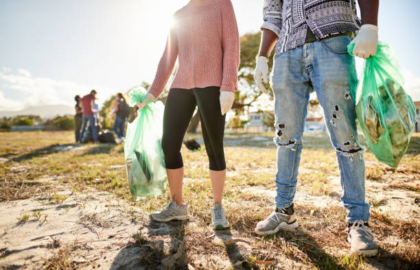 istock Volunteers standing in a field during a community cleanup day 1341912819
