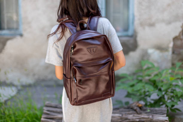 istock Back of woman with brown leather backpack 1341912852