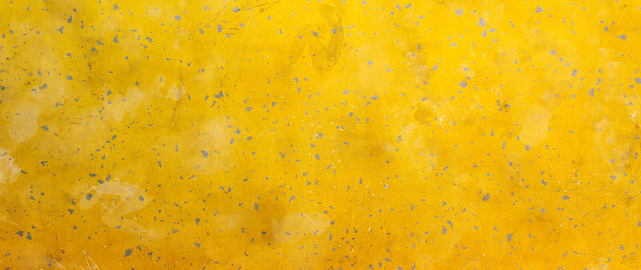Simple rusted sheet metal texture background in yellow color with dirt patches. Wide horizontal composition.