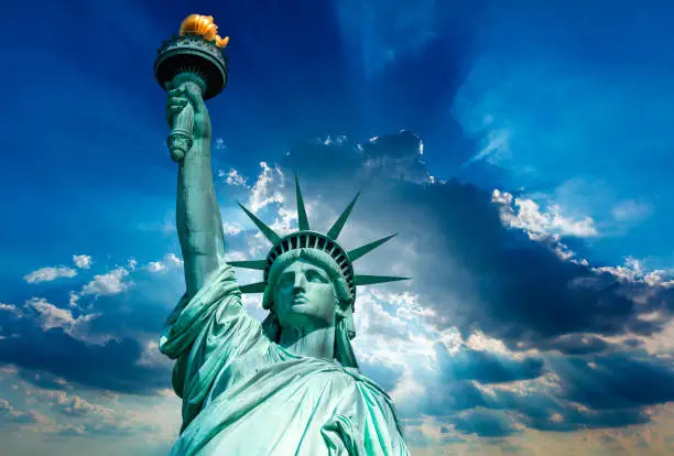Liberty Statue New York American Symbol USA on dramatic sky