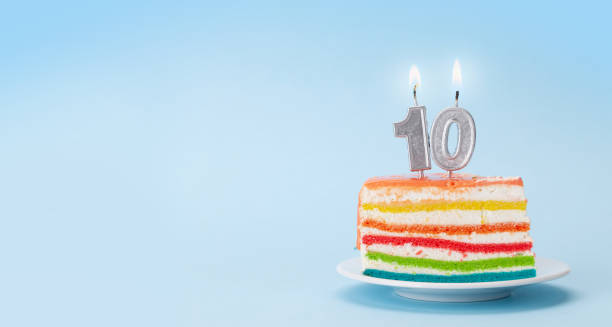 istock Birthday cake with burning number ten candles 1341915531