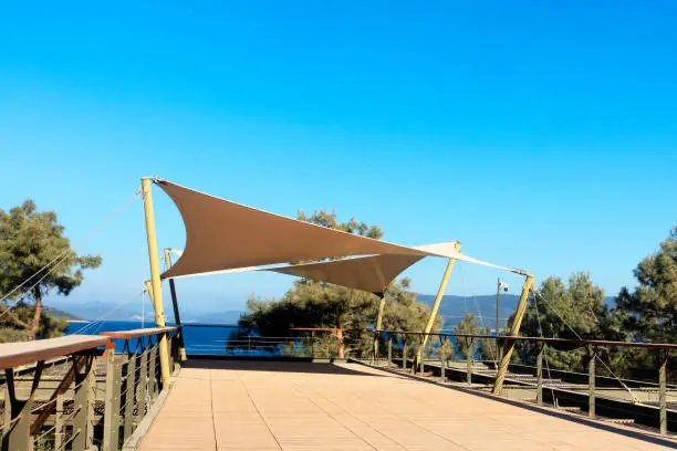 Sun shade sails with sky background.