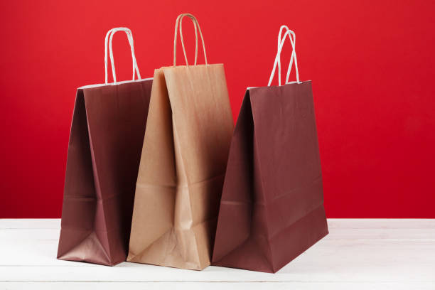 istock Several shopping bags with copy space on red background 1341916715