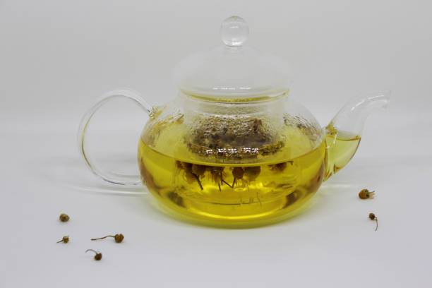 istock Chamomile flowers brewing in hot water. Herbal Chamomile tea for calming effect. 1341917793