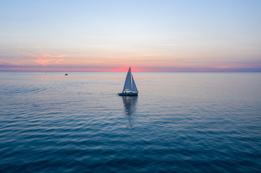 Single boat on Lake Michigan watching the sunset